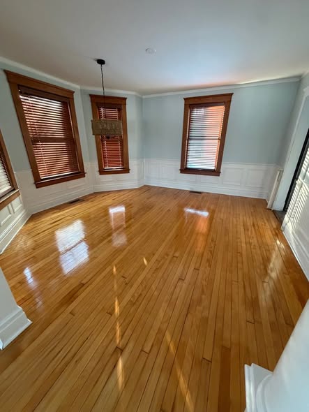 Professional post-construction cleaning crew polishing new West New York home, removing dust, debris, and residue